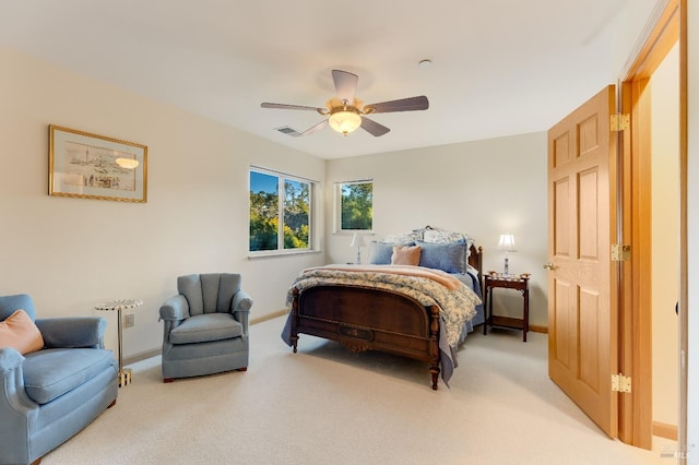 bedroom featuring a ceiling fan, baseboards, visible vents, and light carpet