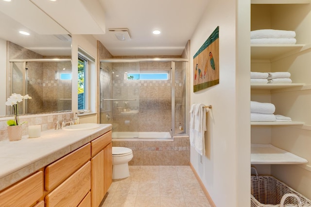 full bathroom with vanity, recessed lighting, tile patterned flooring, tiled shower / bath combo, and toilet