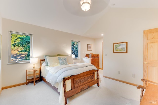 carpeted bedroom with baseboards and vaulted ceiling