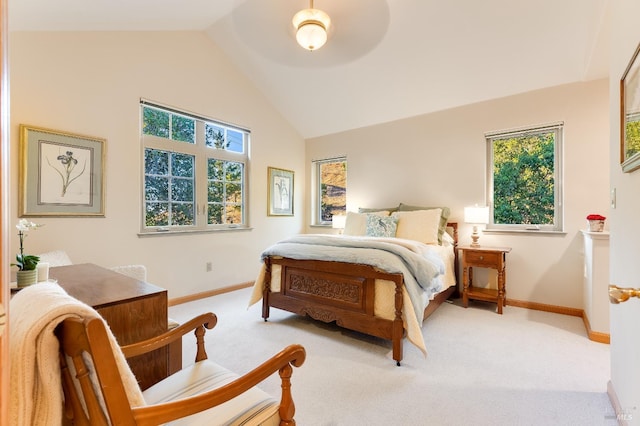 bedroom with ceiling fan, light colored carpet, and vaulted ceiling