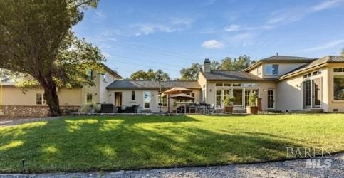 back of house with a lawn