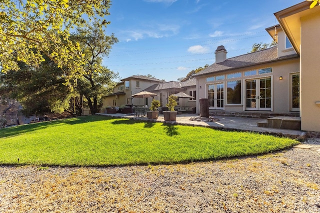 view of yard with french doors and a patio