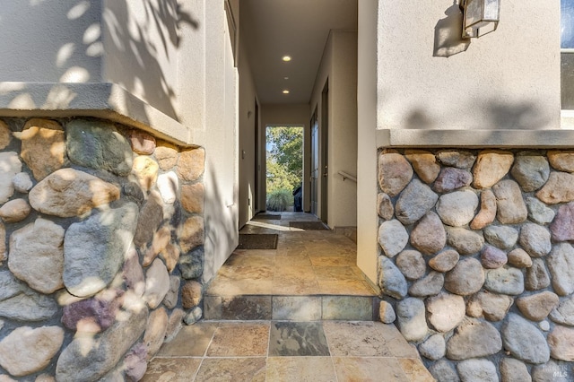 doorway to property featuring stucco siding