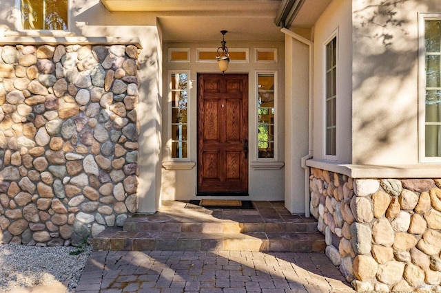 doorway to property with stone siding