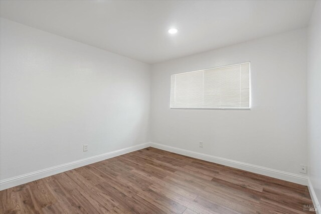 empty room featuring wood-type flooring