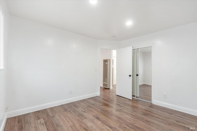 unfurnished bedroom featuring hardwood / wood-style flooring and a closet