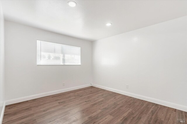 empty room with dark hardwood / wood-style floors