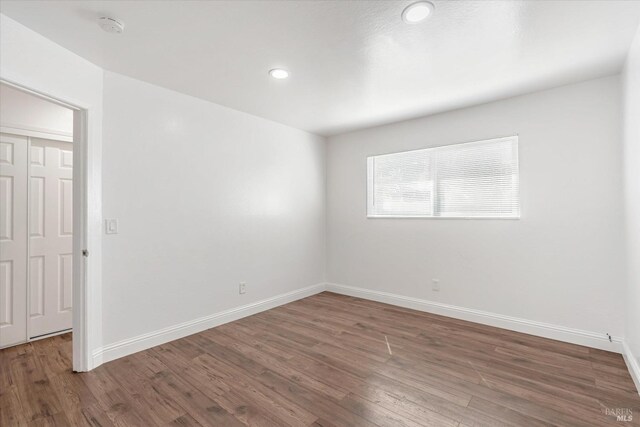 spare room featuring dark wood-type flooring