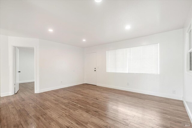 spare room featuring hardwood / wood-style floors