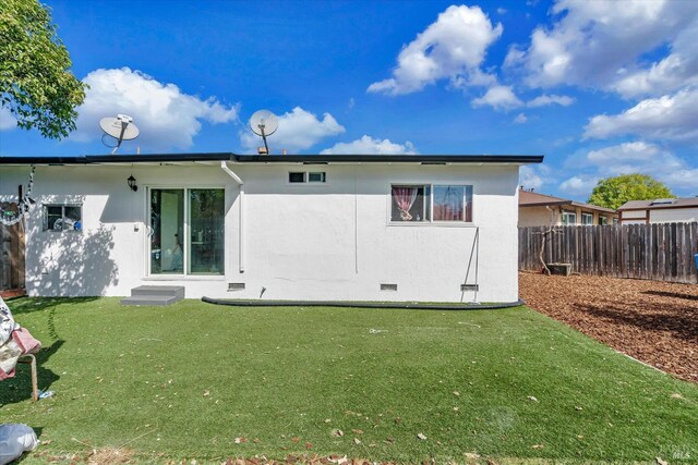 rear view of house with a yard