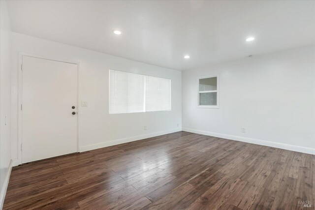 unfurnished room featuring dark hardwood / wood-style flooring