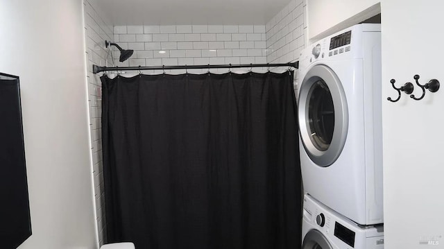 washroom featuring stacked washer and clothes dryer