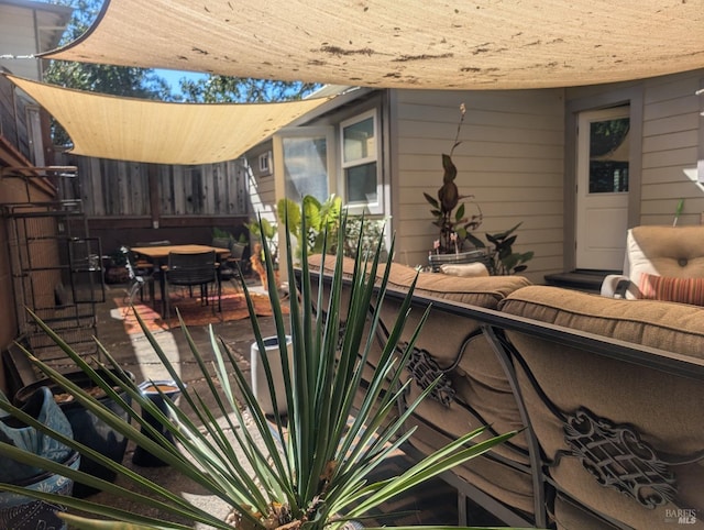 view of patio with outdoor dining area and fence