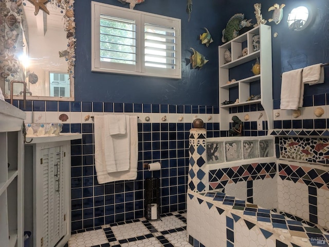 bathroom with tile walls and a wainscoted wall