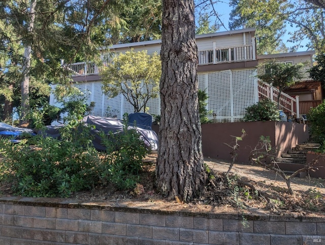 view of side of home featuring stairway