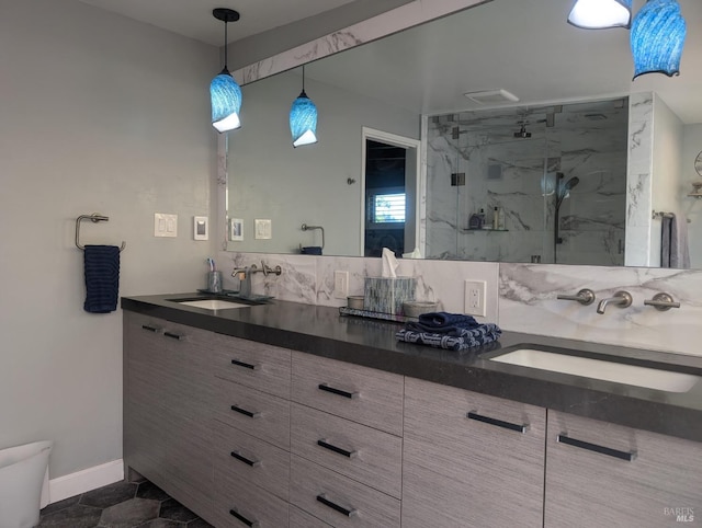 full bath with a sink, backsplash, a marble finish shower, and double vanity
