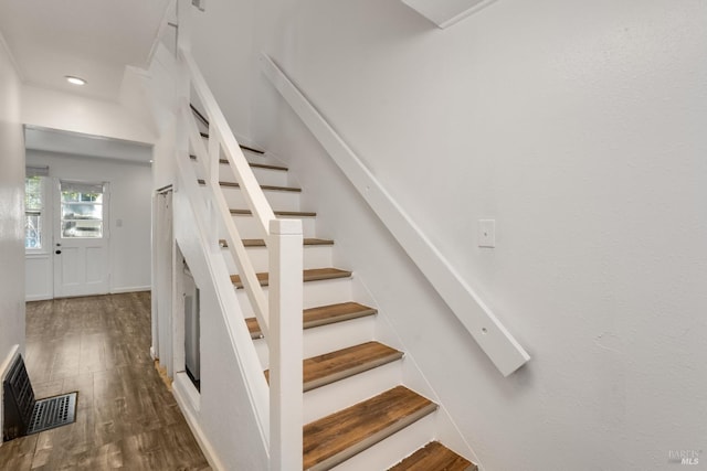 stairs featuring hardwood / wood-style floors