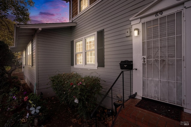 view of exterior entry at dusk