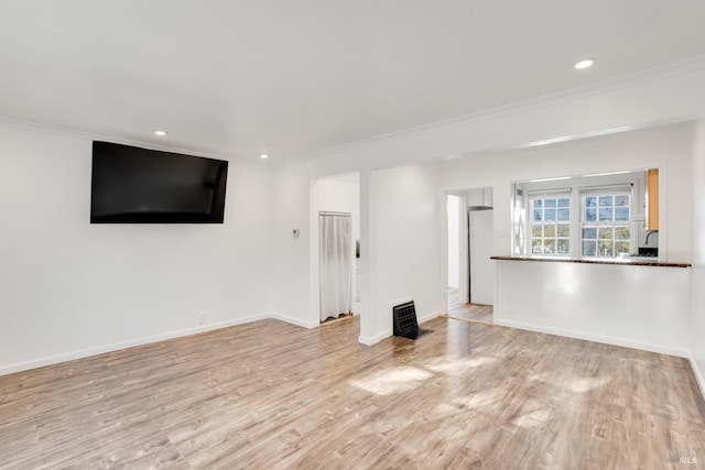 unfurnished living room with ornamental molding and light hardwood / wood-style flooring