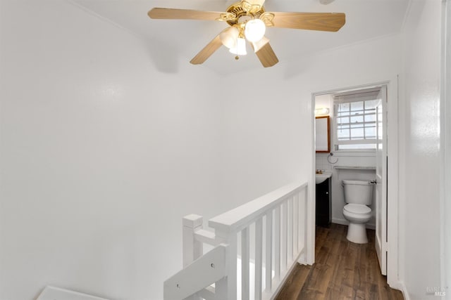 bathroom with toilet, wood-type flooring, ceiling fan, and crown molding