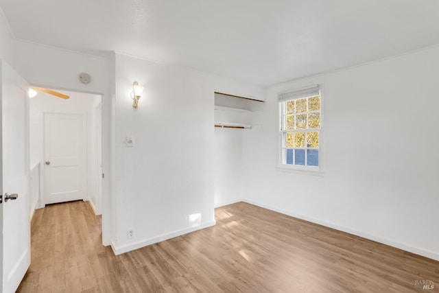 spare room with light hardwood / wood-style floors and ceiling fan