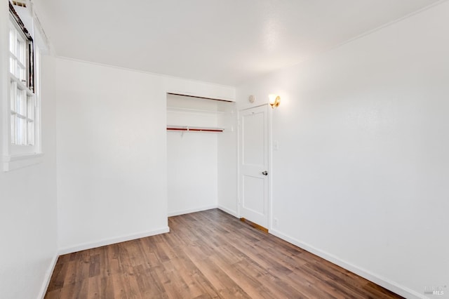 unfurnished bedroom with a closet and light wood-type flooring