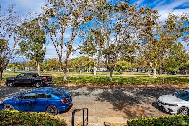 view of vehicle parking featuring a lawn