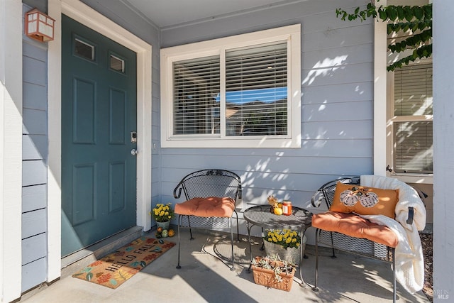 view of exterior entry with covered porch