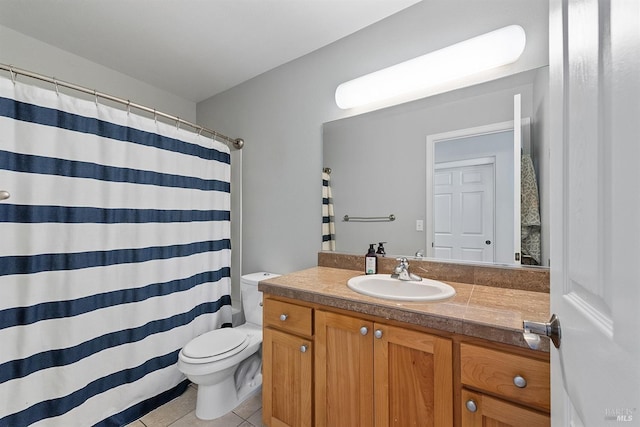 bathroom with tile patterned floors, walk in shower, vanity, and toilet