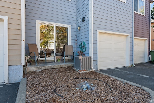 exterior space featuring cooling unit and a garage