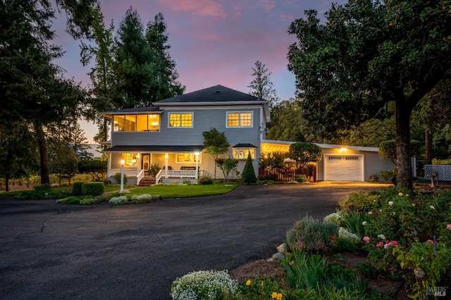 view of front of property featuring a porch and a garage