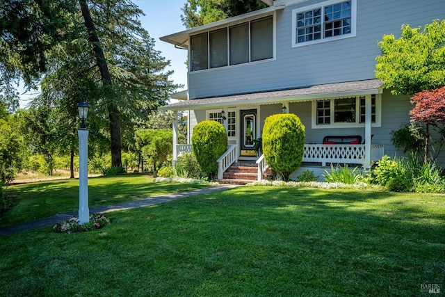 view of front facade with a front lawn and covered porch