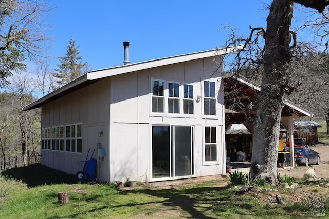 rear view of property featuring a yard