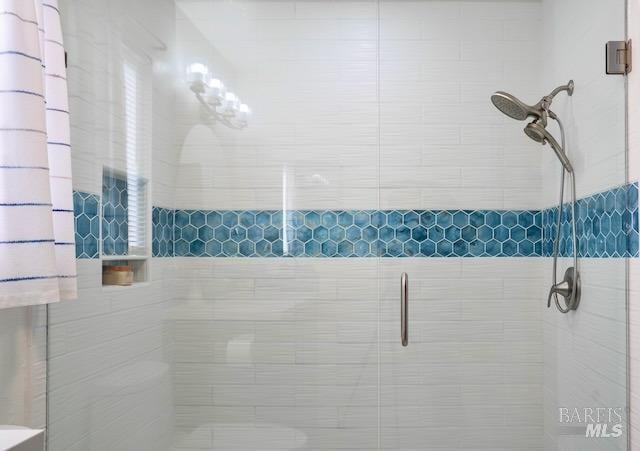 bathroom with a shower with shower door