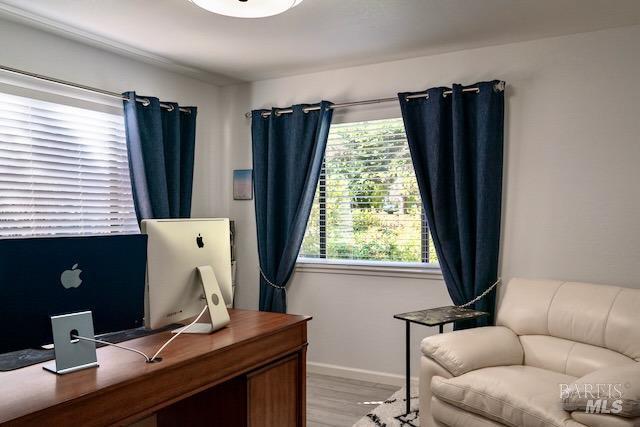 office space featuring light wood-type flooring and baseboards
