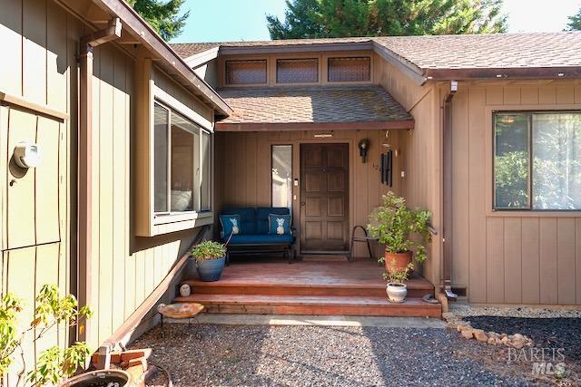 view of exterior entry featuring a deck