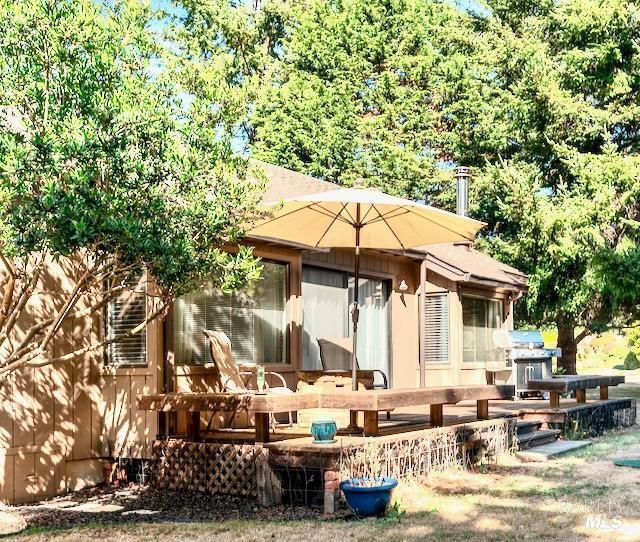 back of property featuring a wooden deck