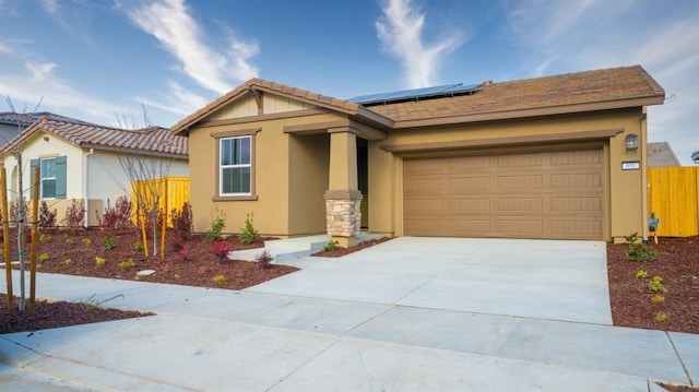 view of front of home featuring a garage and solar panels