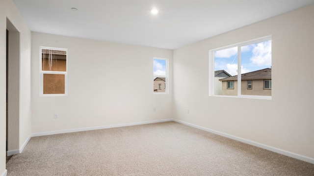 carpeted empty room featuring a healthy amount of sunlight