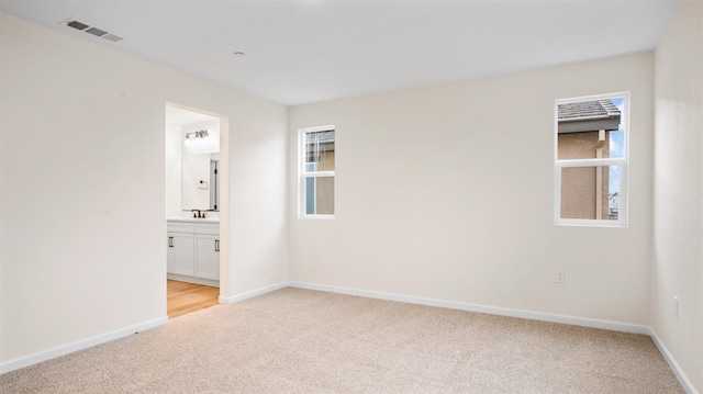 carpeted empty room with sink