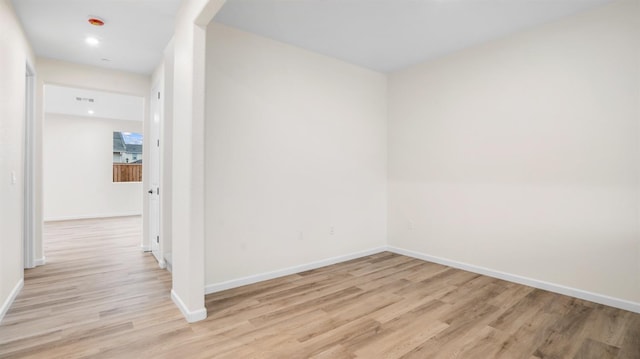 spare room featuring light hardwood / wood-style flooring