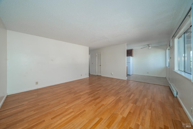 15 Royale Ave, Lakeport, CA 95453 - spare room featuring ceiling fan, a textured ceiling, light hardwood / wood-style floors, and a baseboard heating unit