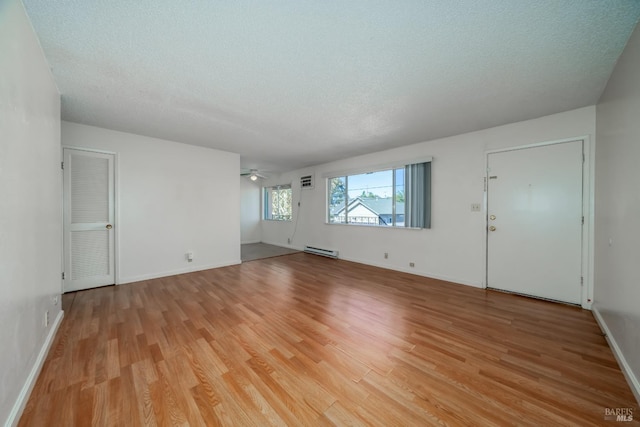 15 Royale Ave, Lakeport, CA 95453 - unfurnished room featuring ceiling fan, light hardwood / wood-style floors, baseboard heating, and a textured ceiling