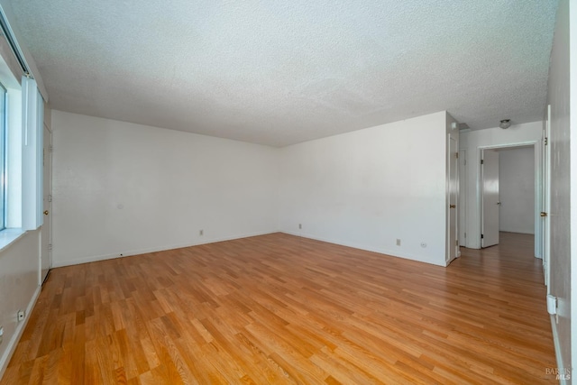 15 Royale Ave, Lakeport, CA 95453 - empty room featuring plenty of natural light, light wood-type flooring, and a textured ceiling