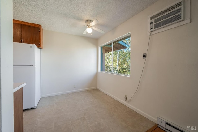 15 Royale Ave, Lakeport, CA 95453 - interior space with ceiling fan, a baseboard radiator, a textured ceiling, and a wall unit AC