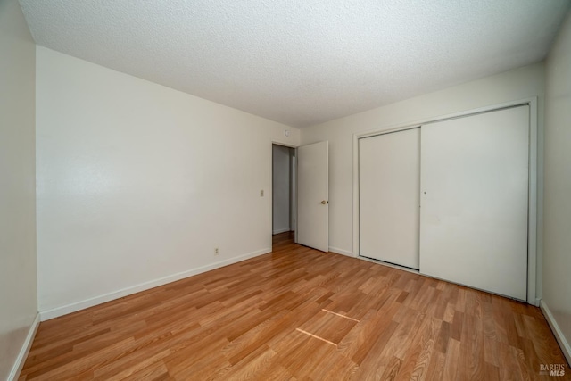 15 Royale Ave, Lakeport, CA 95453 - unfurnished bedroom featuring a textured ceiling, light wood-type flooring, and a closet