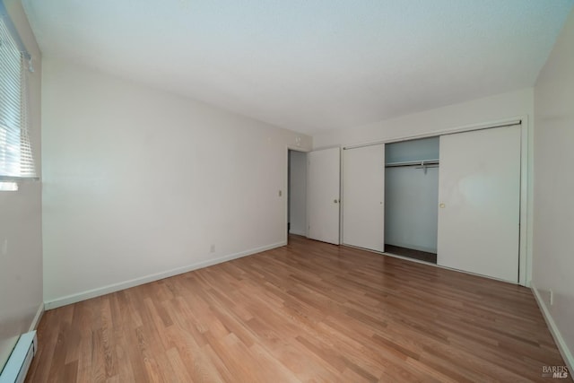 15 Royale Ave, Lakeport, CA 95453 - unfurnished bedroom featuring a baseboard radiator, a closet, and light hardwood / wood-style floors