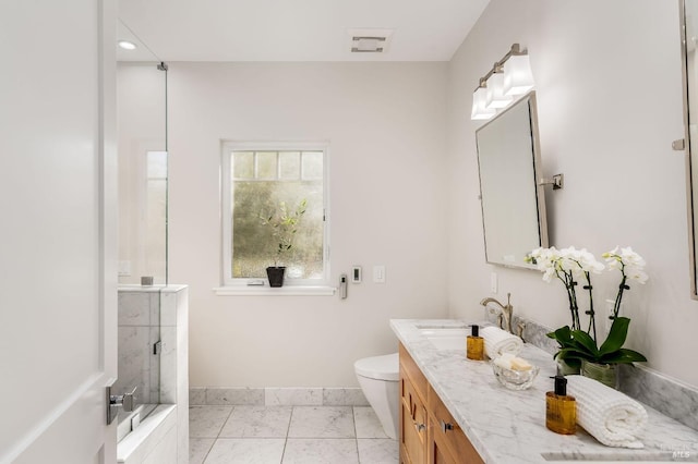 bathroom featuring walk in shower, vanity, and toilet