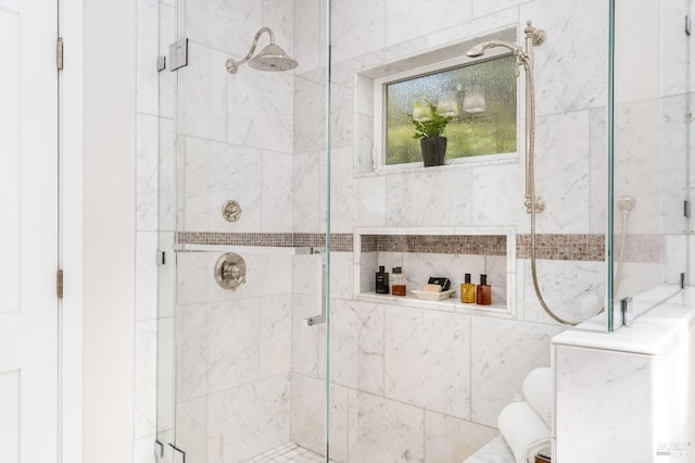 bathroom with a shower with shower door