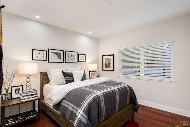 bedroom with dark hardwood / wood-style floors